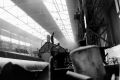 A welder on top of a tank in a manipulator in 108 Dept of Butterfields. 1960s.